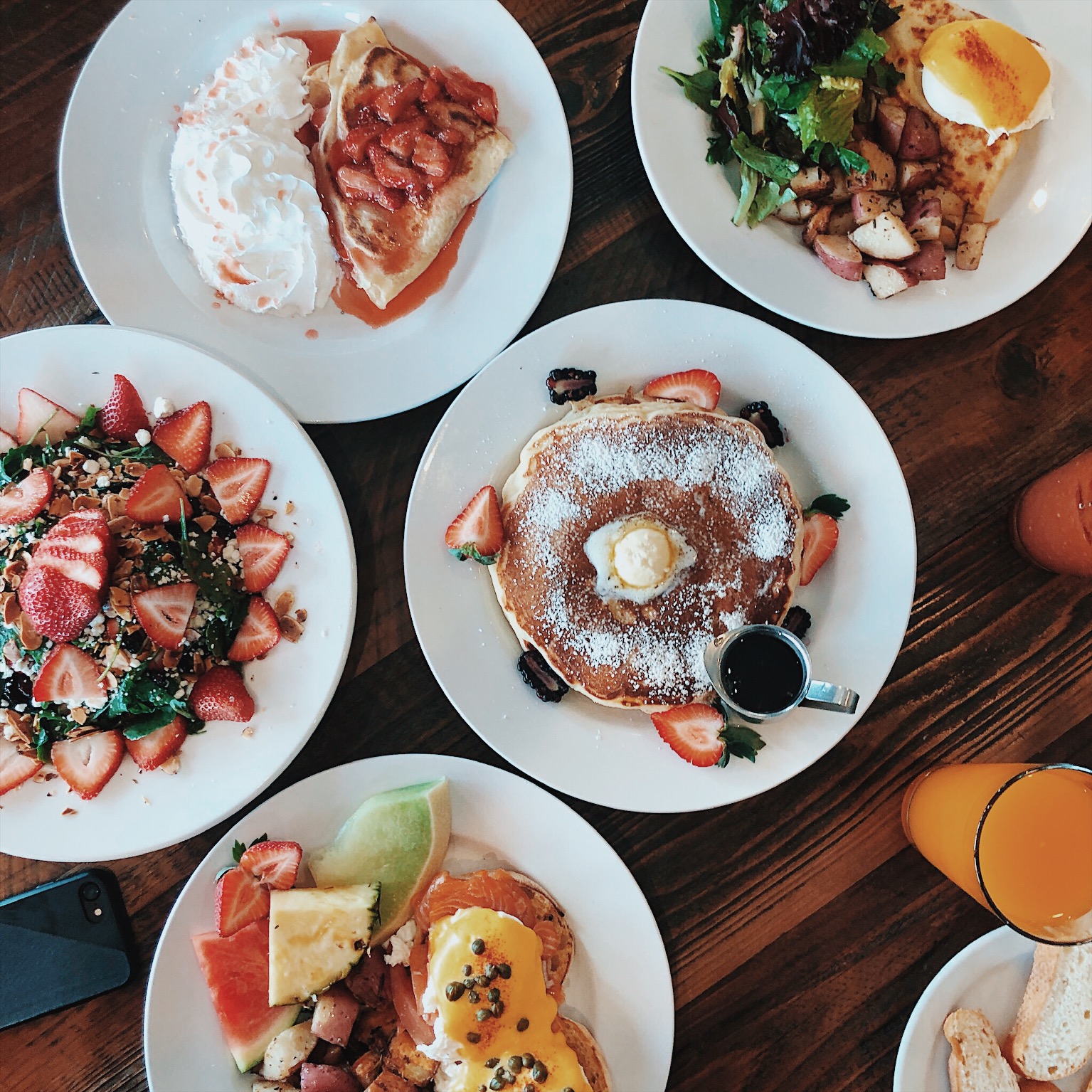 Brunch at Crepes on Cole: strawberry crepe with whipped cream, pancakes, eggs Benedict, home fries and strawberry spinach salad