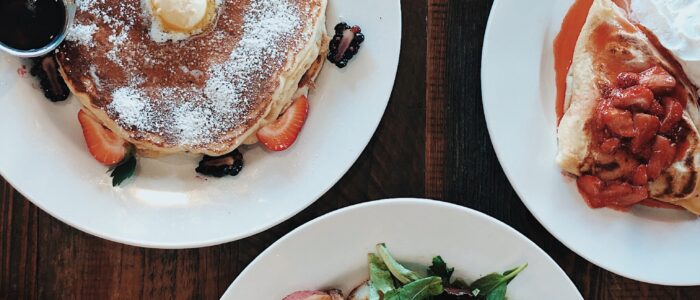 Homemade pancakes with strawberries Homemade pancakes with powdered sugar and fresh strawberries beside a strawberry crepe at Crepes on Cole in San Francisco